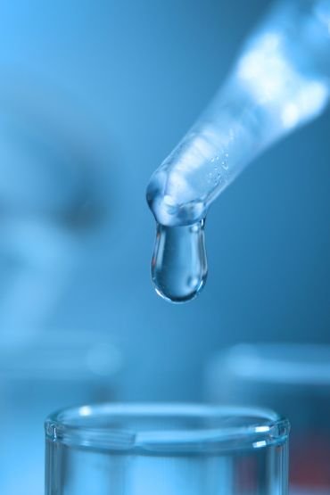 Technician operating lab equipment for product testing